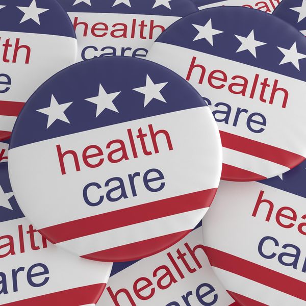 Pile of Health Care Buttons With US Flag