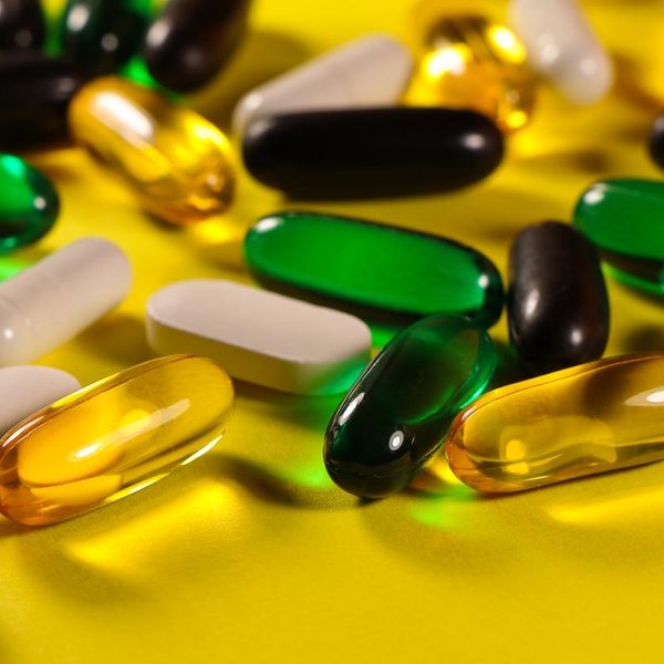Pill And Capsule Variety On Bright Yellow Surface