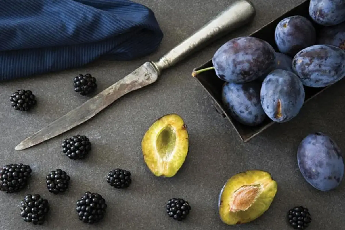 plums and blackberries on the table