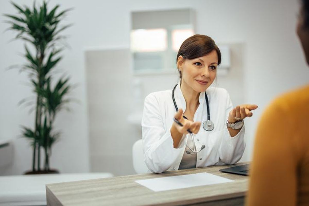 Portrait of a doctor discussing with a patient