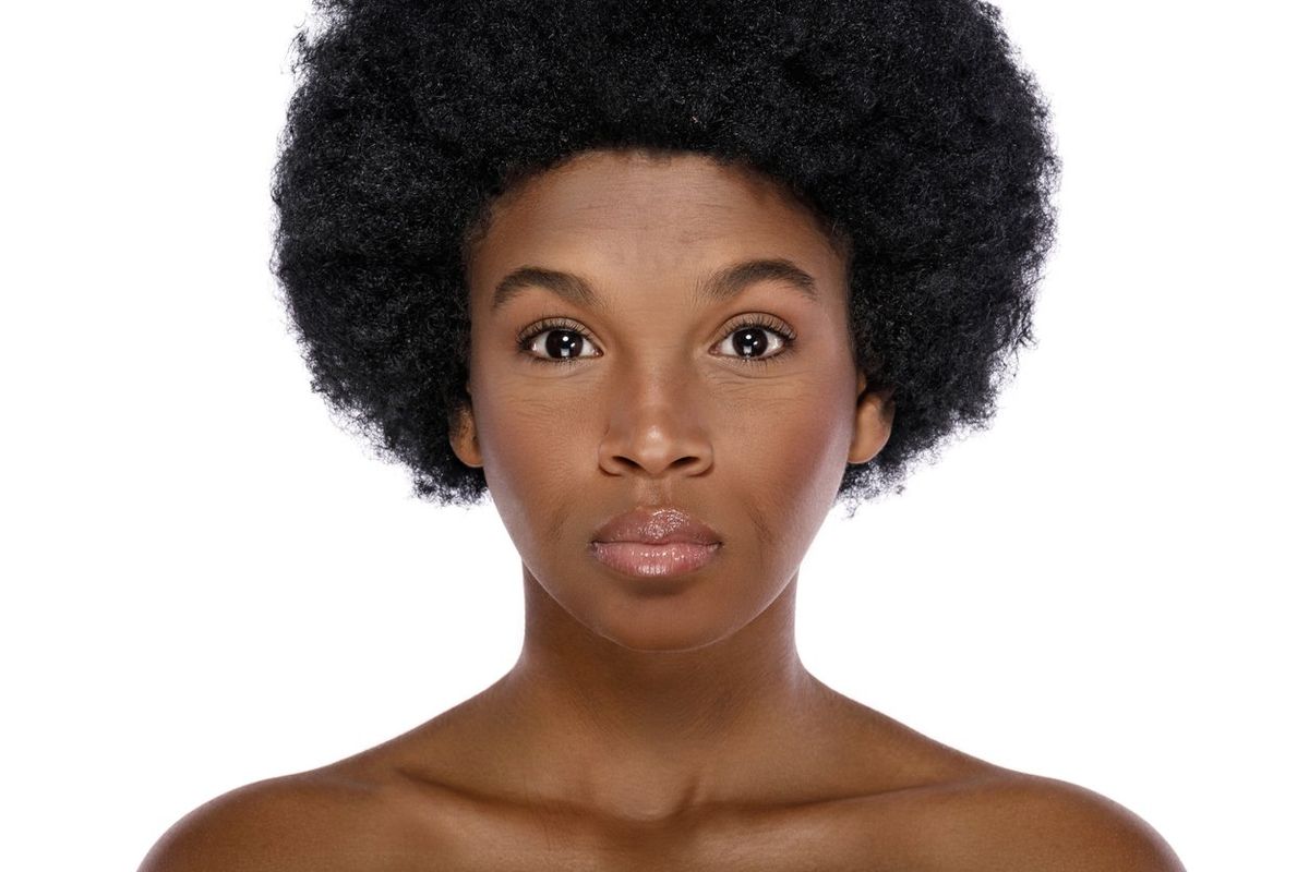 Portrait of middle aged beautiful african woman on white background