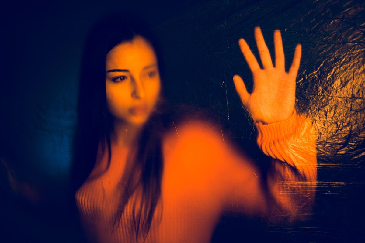 Portrait of teenage girl trapped behind the plastic