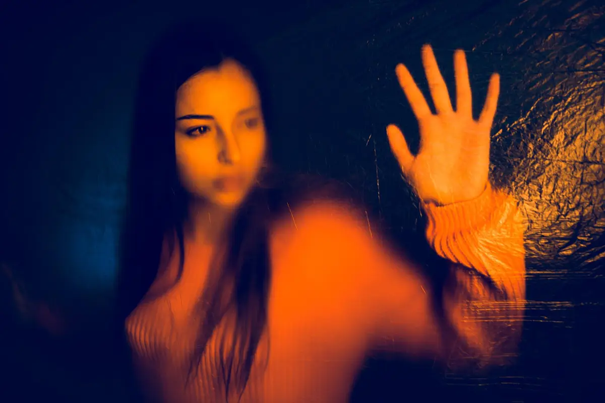 Portrait of teenage girl trapped behind the plastic