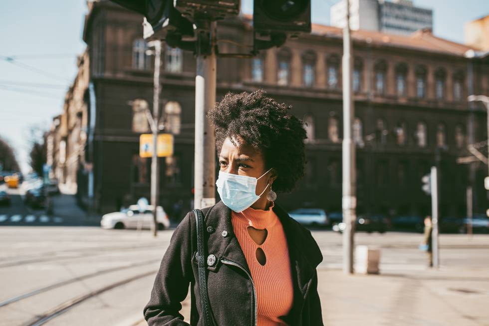 Portrait Of Young Woman With Mask On The Street