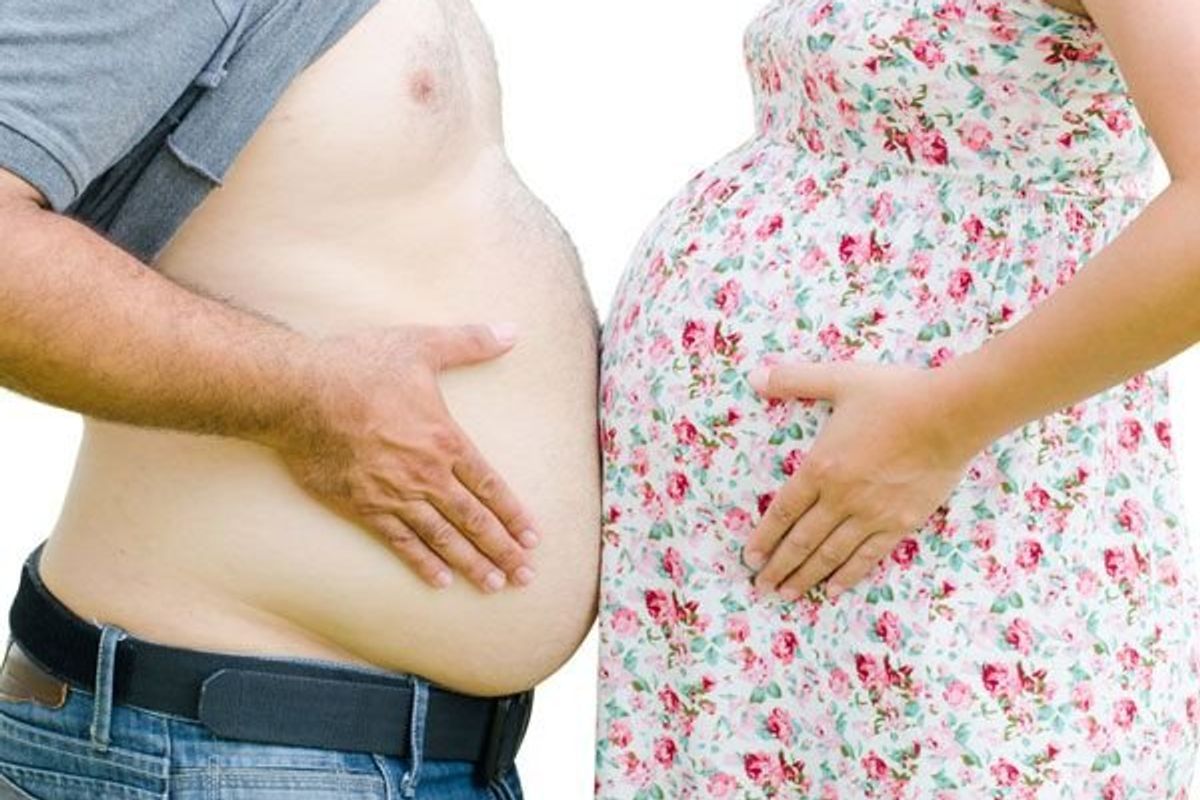 pregnant couple touching stomachs