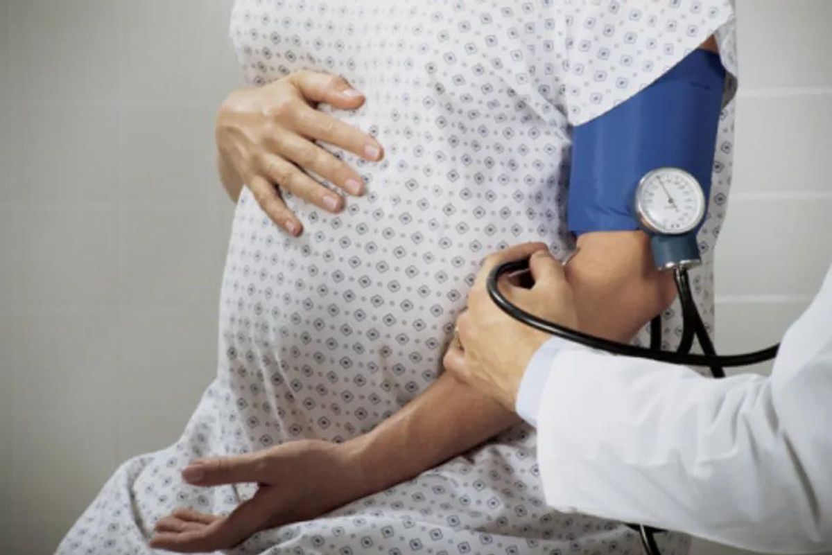 pregnant woman getting her blood pressure taken