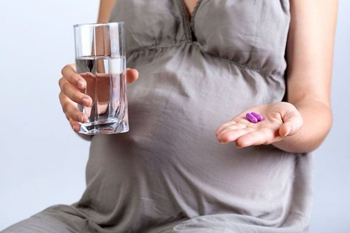 pregnant woman taking vitamins