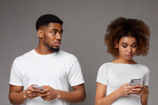 Sad black man looking at his girlfriend