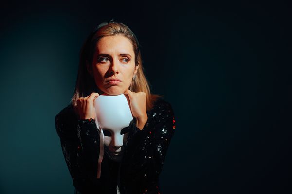 Sad Woman Holding a Theater Mask Feeling Depressed