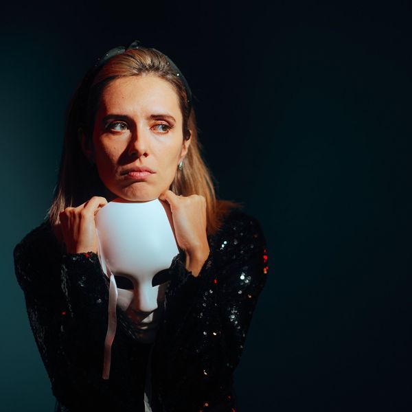 Sad Woman Holding a Theater Mask Feeling Depressed