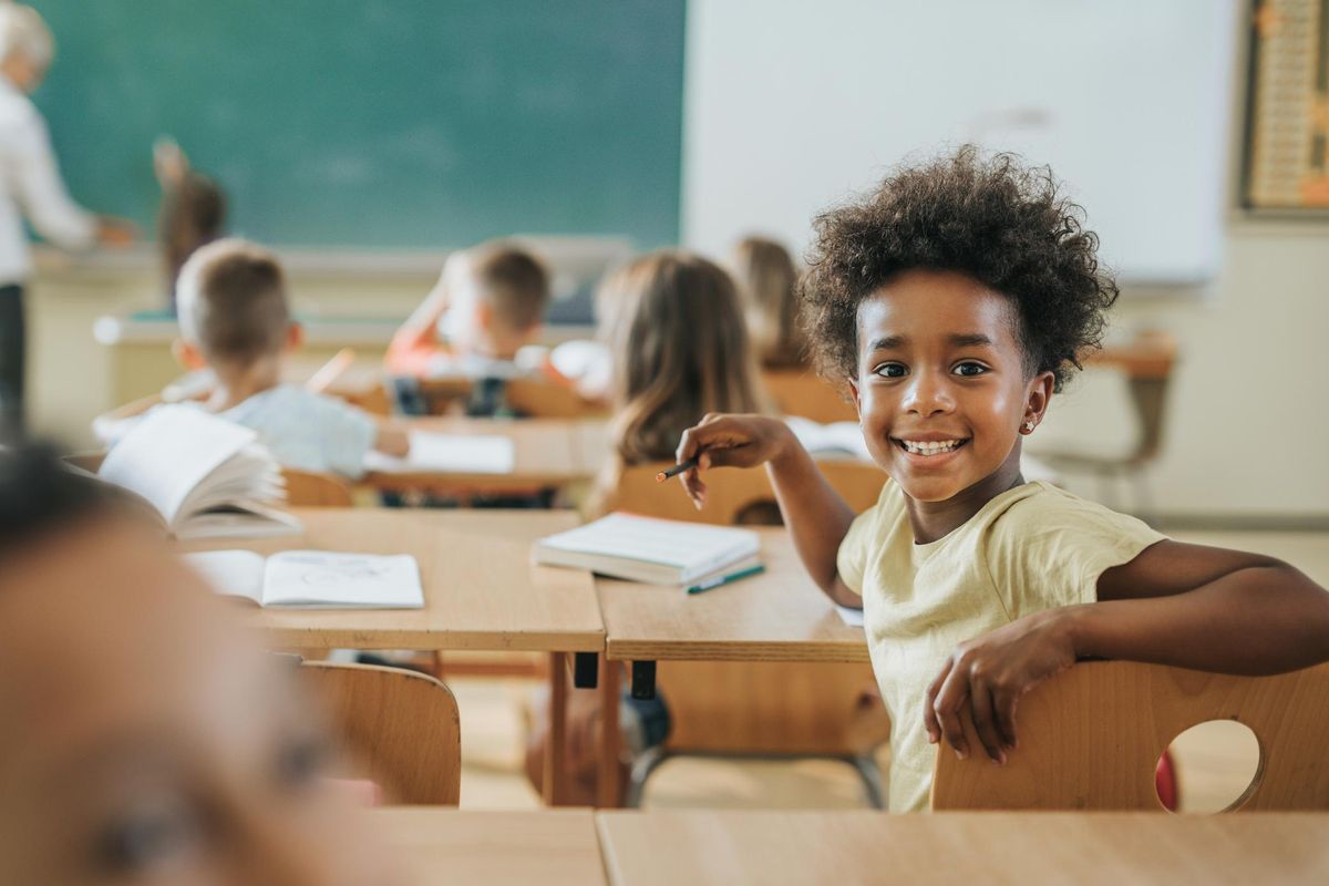 school girl sitting at her desk in a classroom