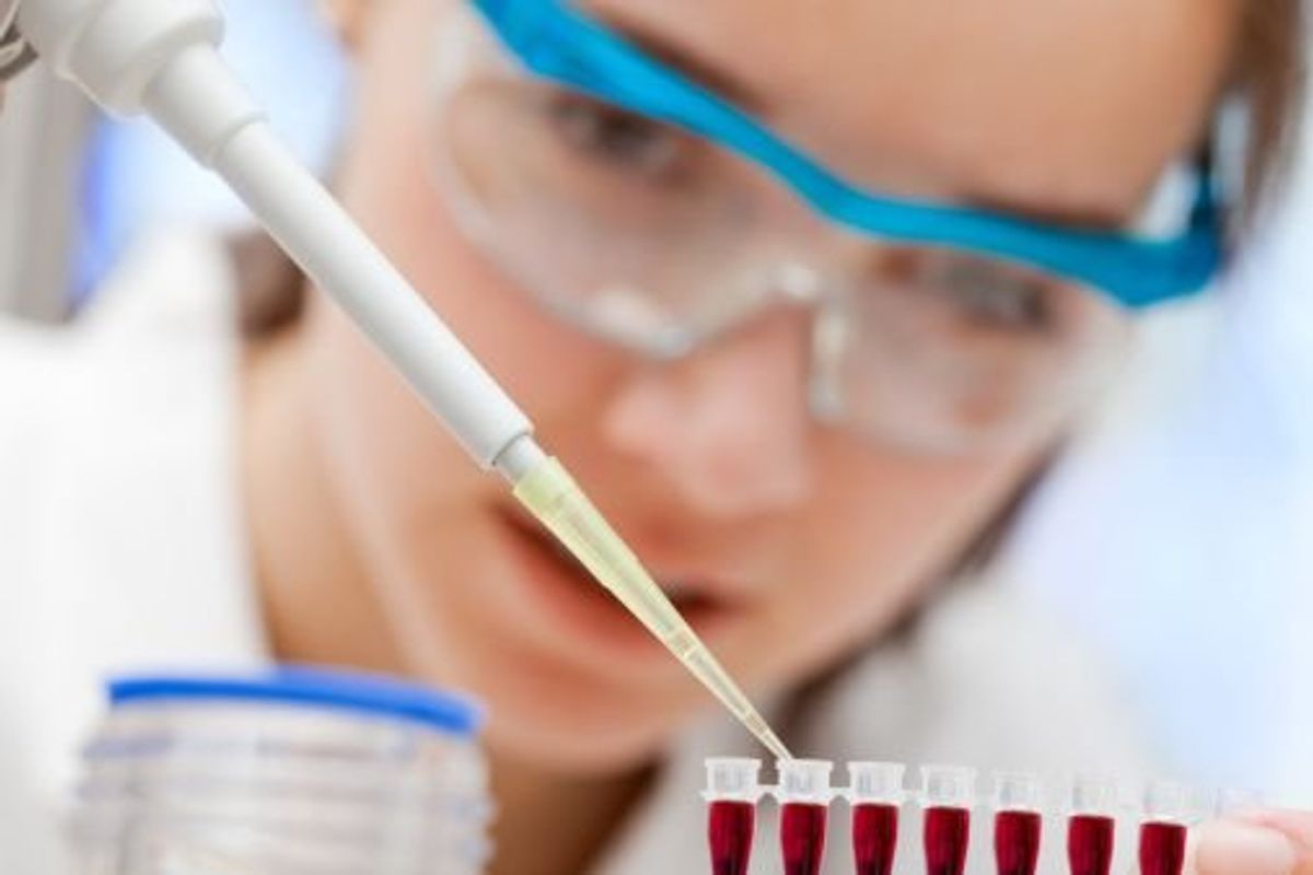 scientist putting a liquid in vials
