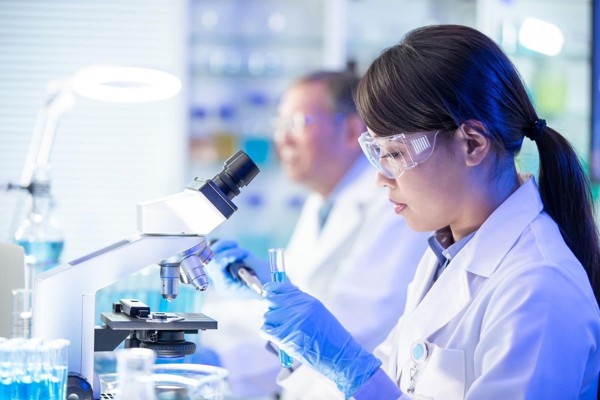 scientist using microscope