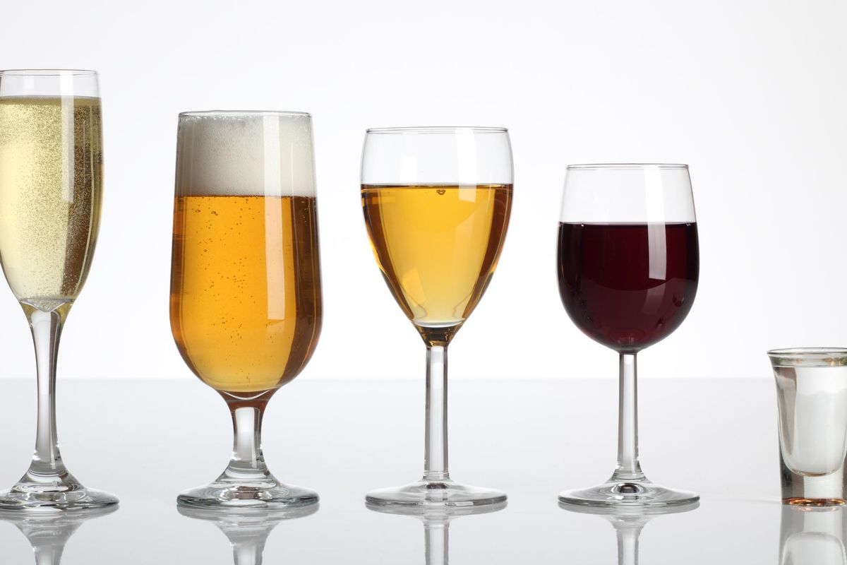 Selection of alcoholic beverages on a plain gray background
