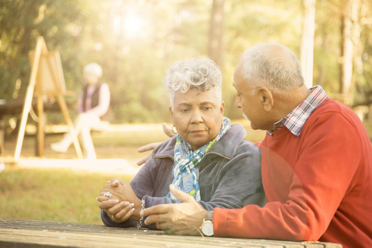 senior adult couple talk at outdoor park