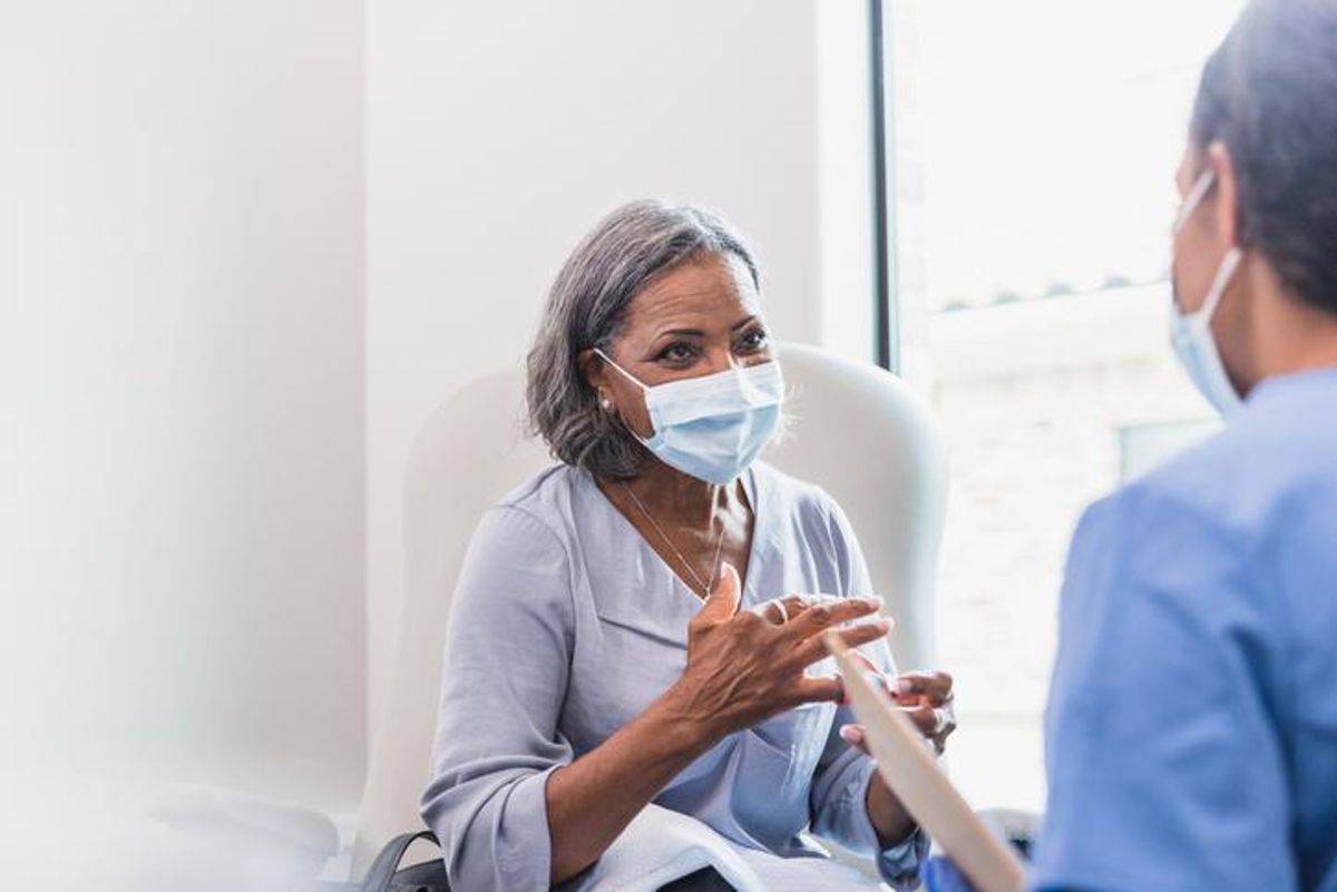 Senior adult patient talks with doctor