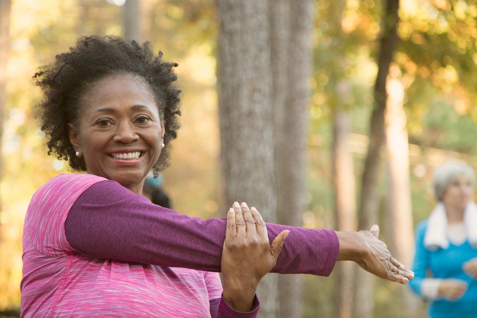 senior adults exercising, yoga class outdoors