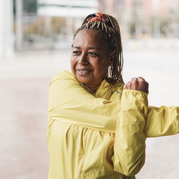 Senior african woman stretching during workout routine