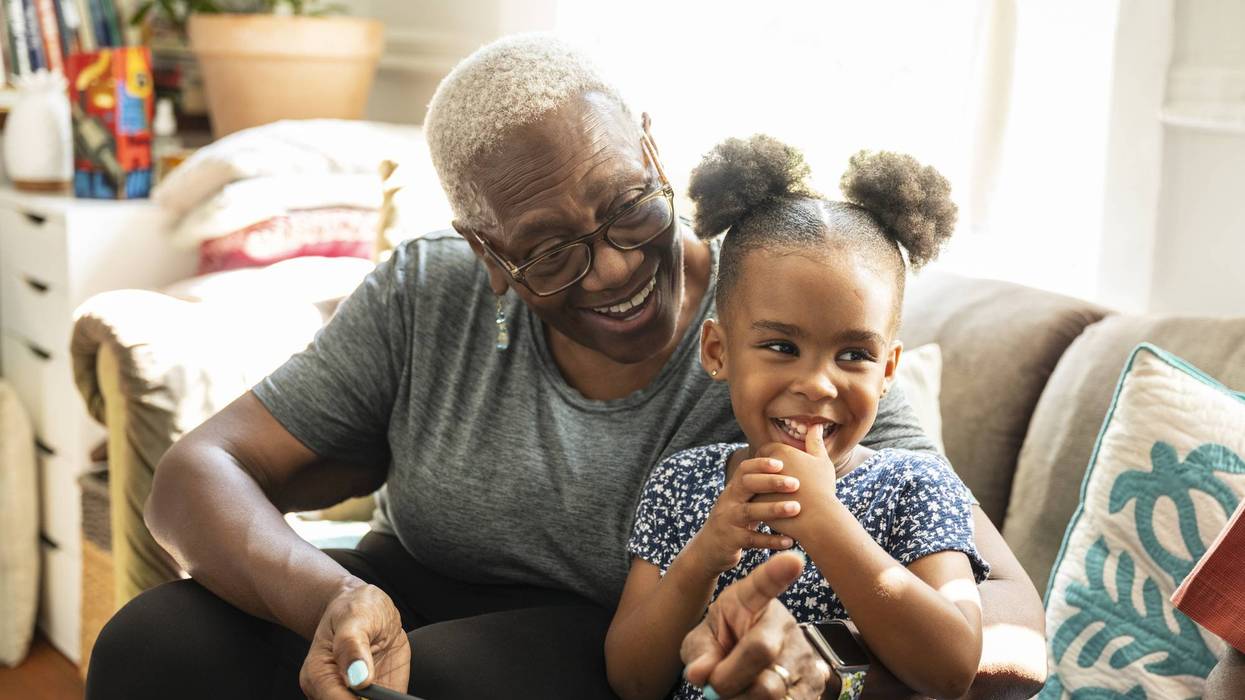 senior and granddaughter using smart phone