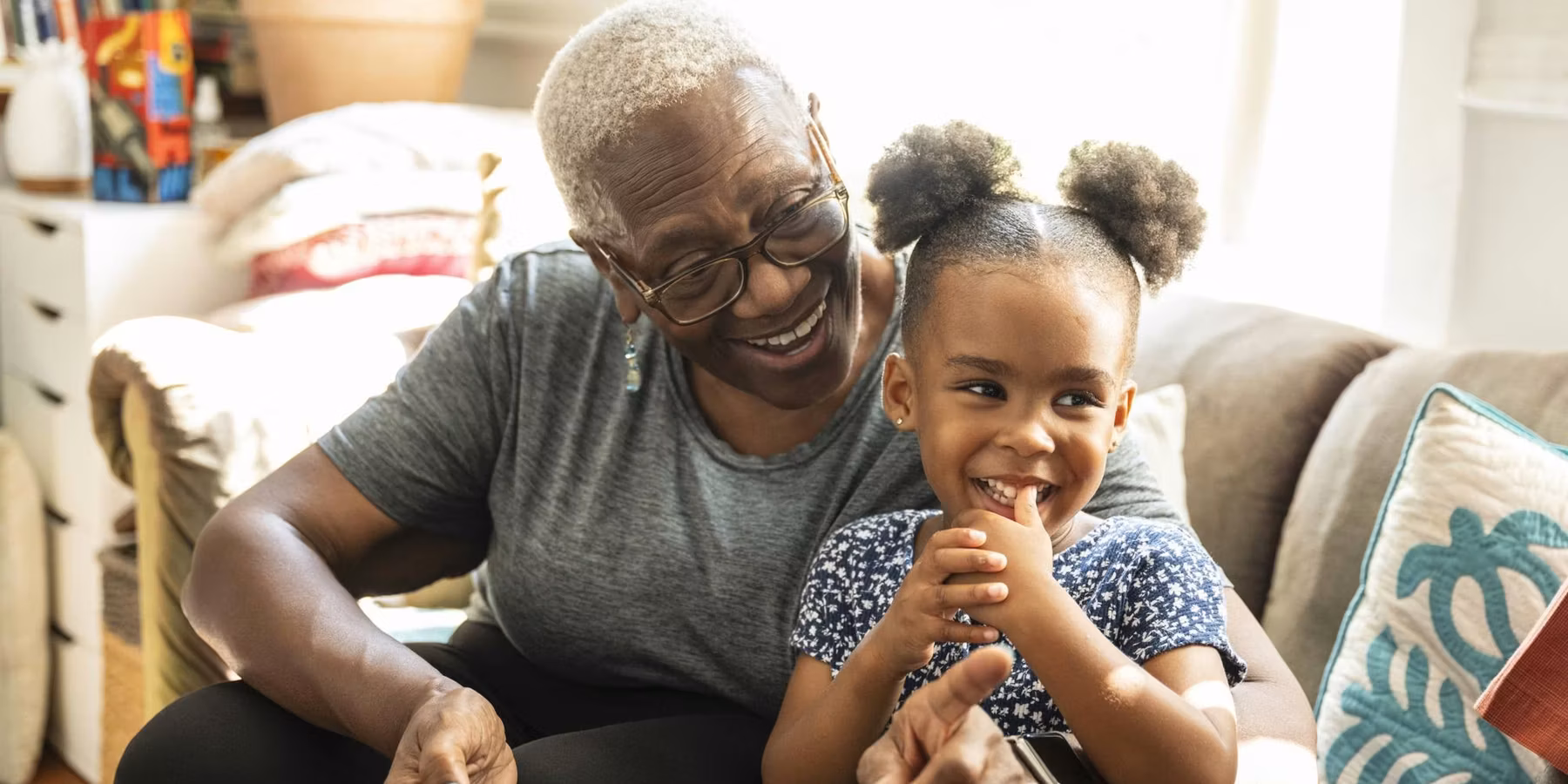 senior and granddaughter using smart phone