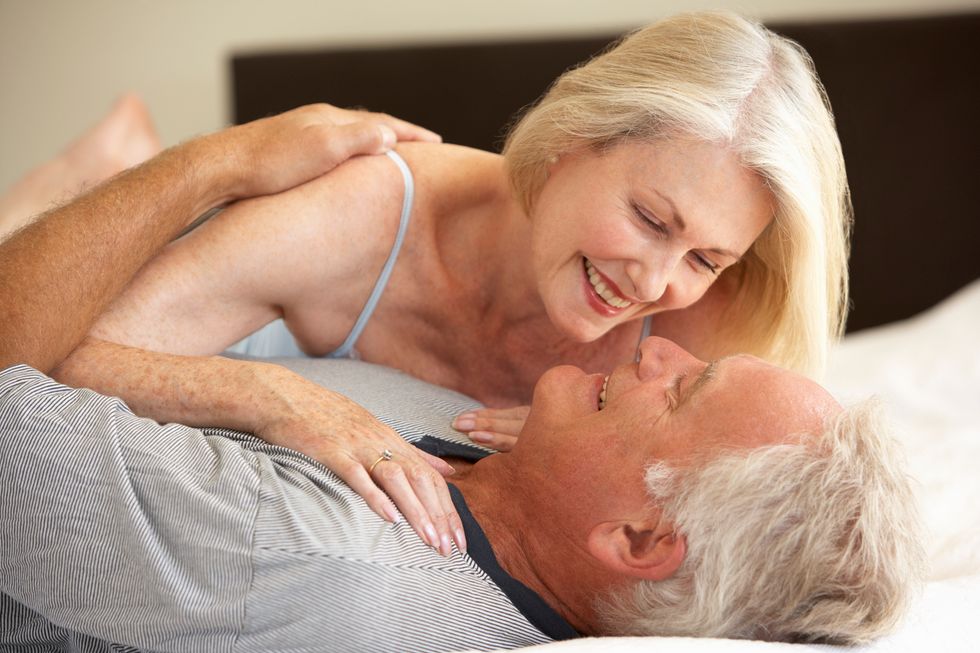 Senior Couple Relaxing On Bed