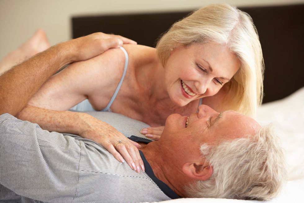 Senior Couple Relaxing On Bed