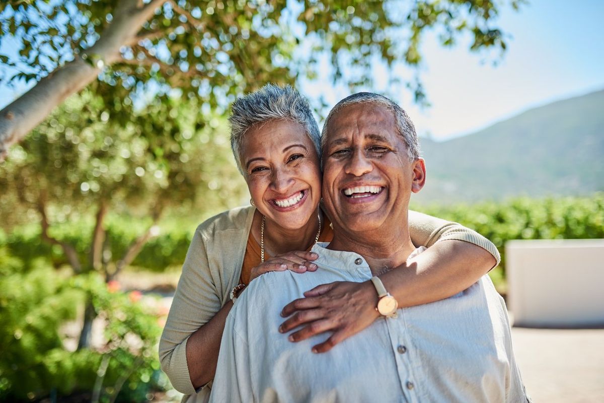 Senior couple, smile and outdoor in nature park showing love