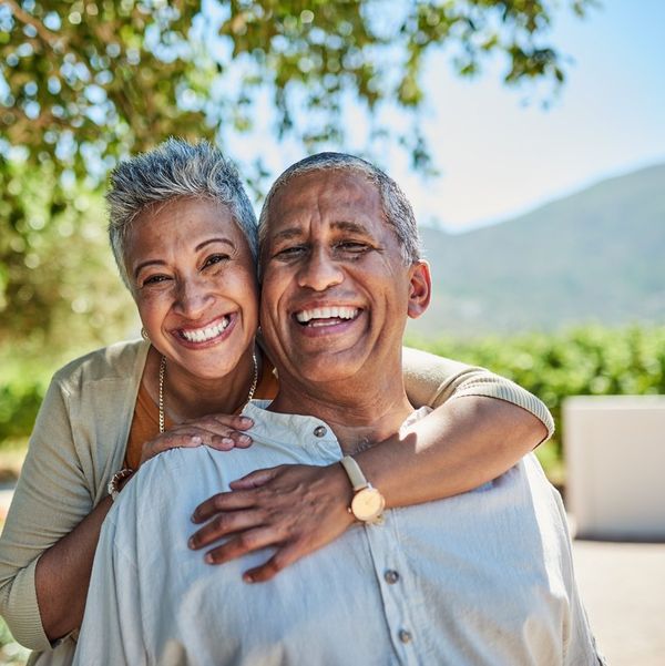 Senior couple, smile and outdoor in nature park showing love