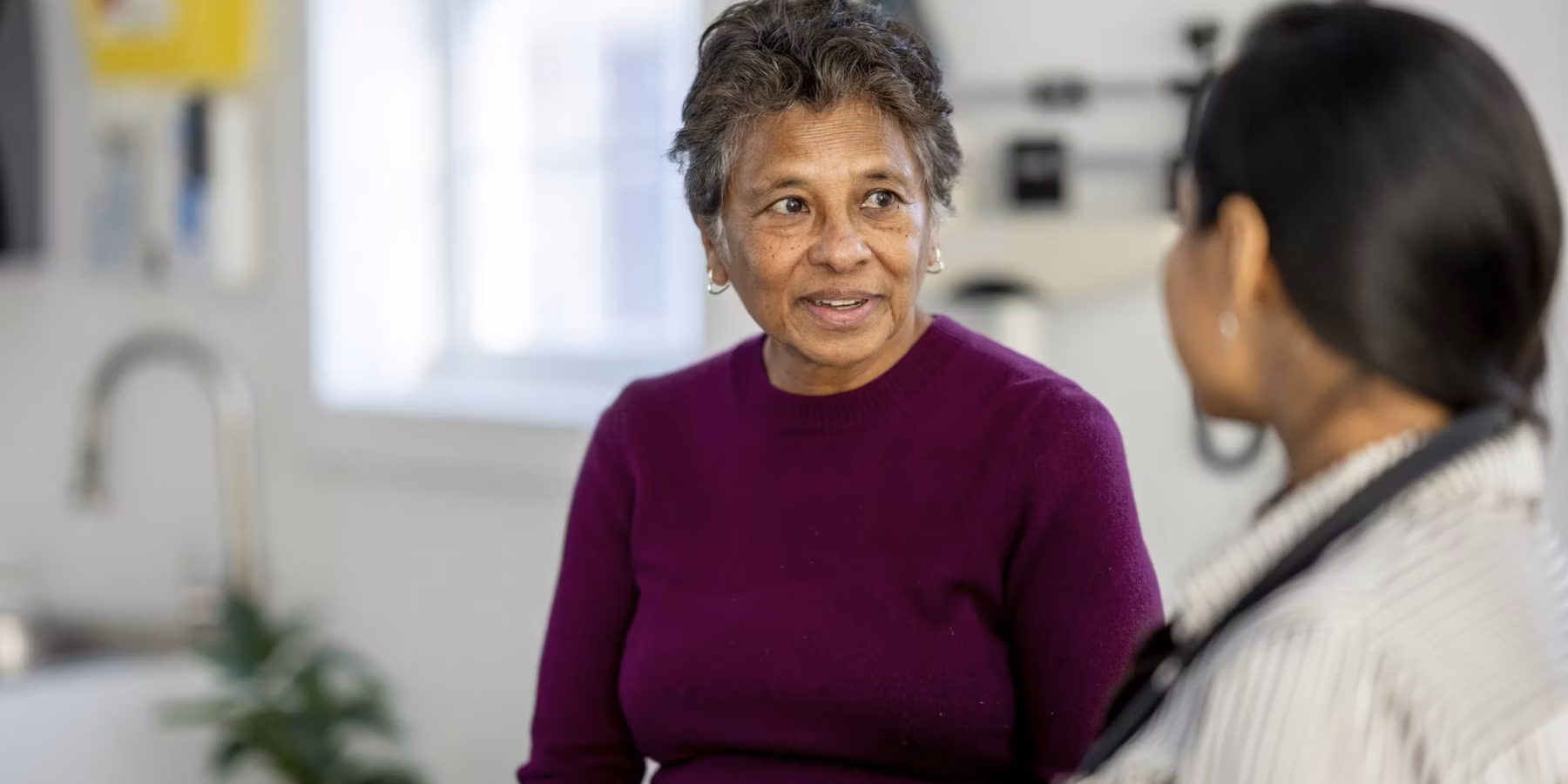 Senior Woman Consulting With Female Doctor During Medical Checkup