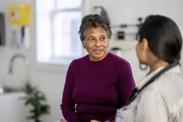 Senior Woman Consulting With Female Doctor During Medical Checkup