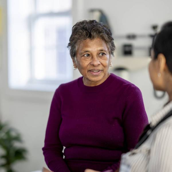 Senior Woman Consulting With Female Doctor During Medical Checkup