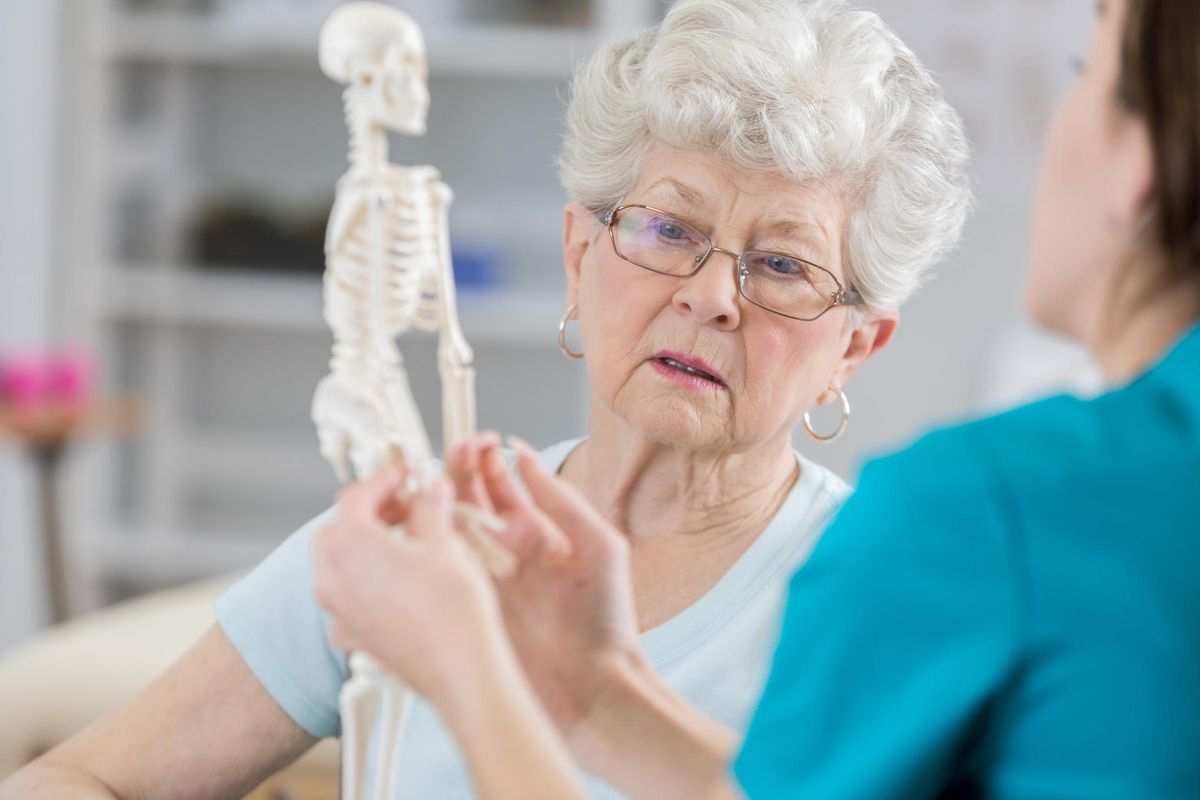 Senior woman discusses posture with physical therapist