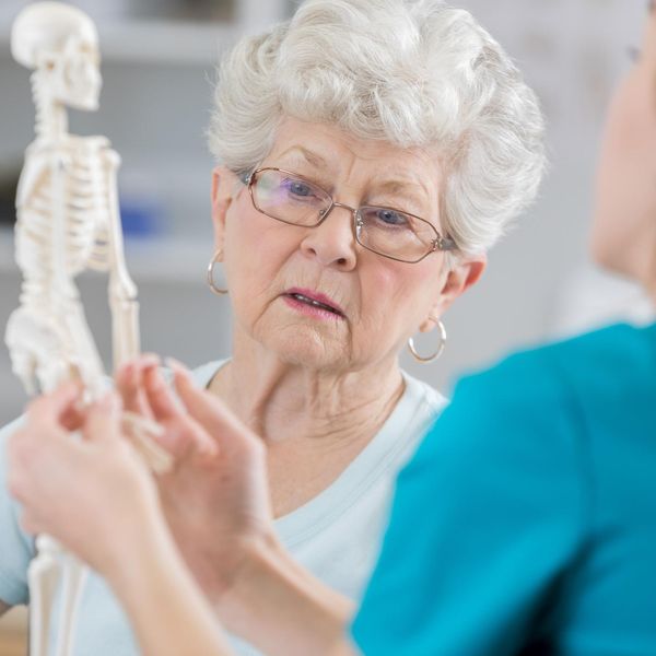 Senior woman discusses posture with physical therapist