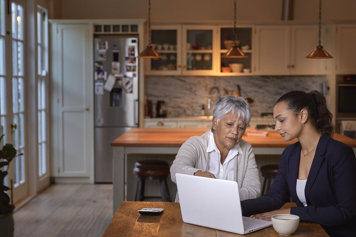 senior woman having a consultation with a financial advisor at home