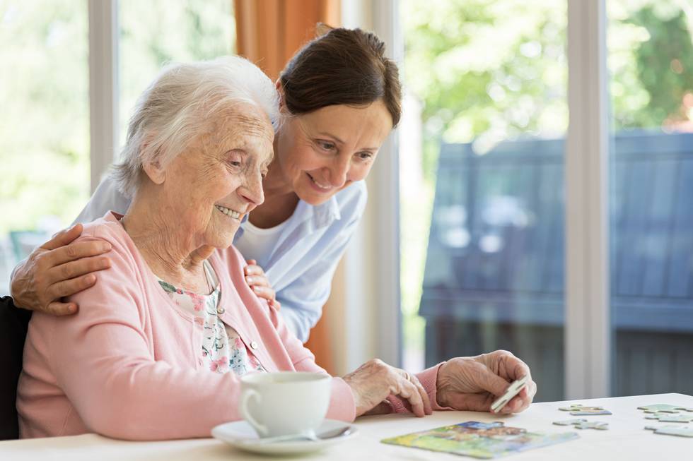 senior woman in wheelchair with caregiver