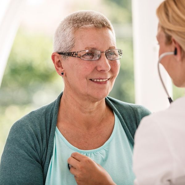 senior woman receiving medical examination at doctor's office.