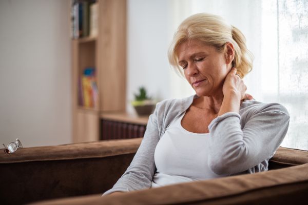senior woman with Chronic Fatigue Syndrome sitting in a living room