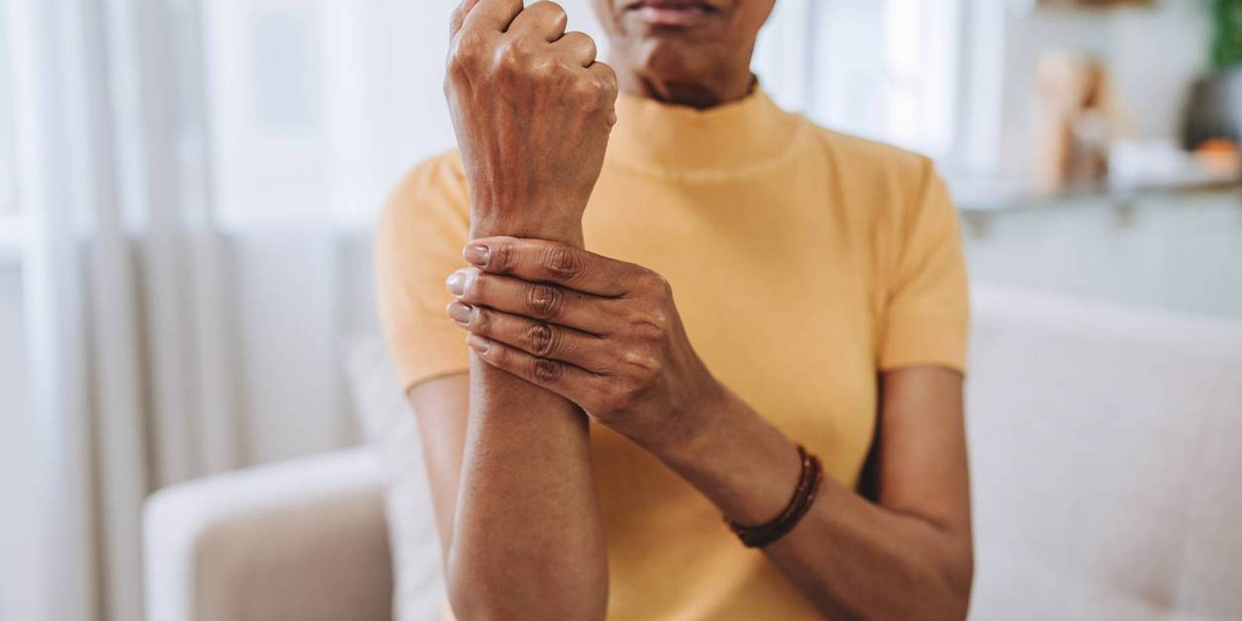 Senior woman with wrist pain at home