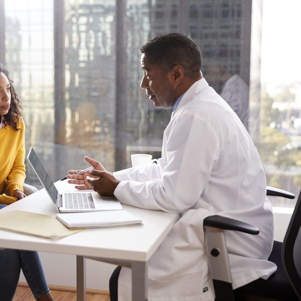 Serious Woman Having Consultation With Male Doctor