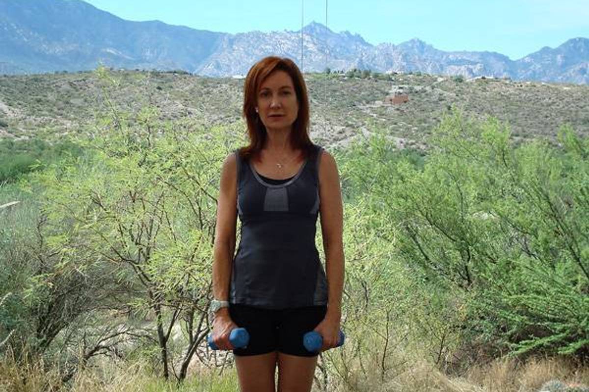 sheryl holding dumbbells