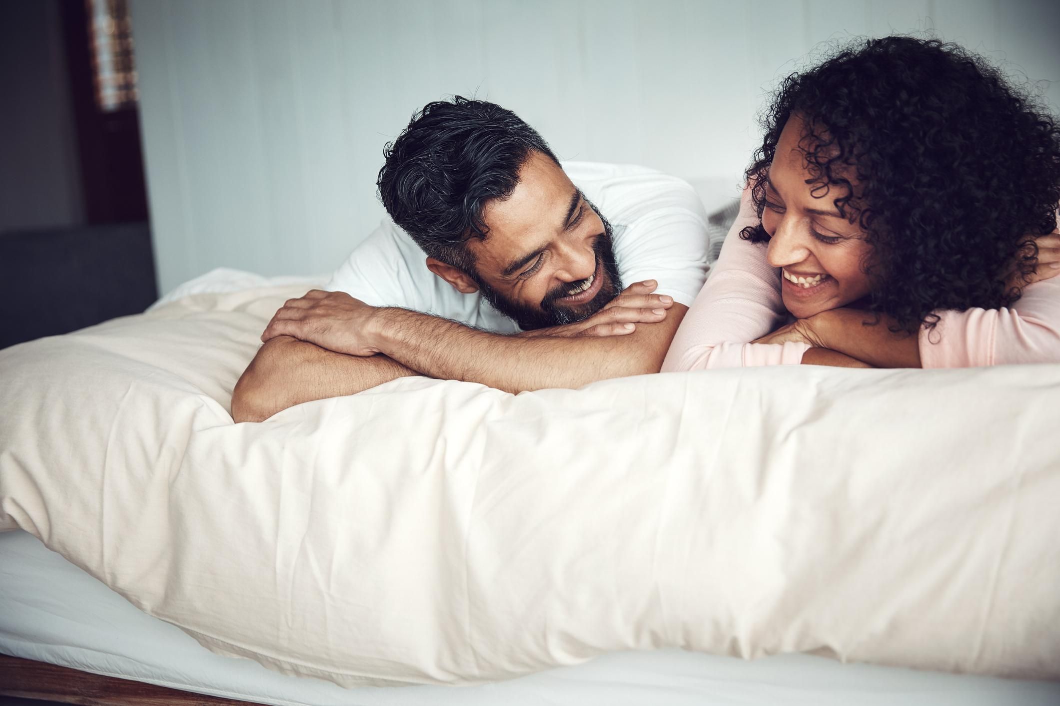 Shot of a mature couple relaxing together on the bed at home