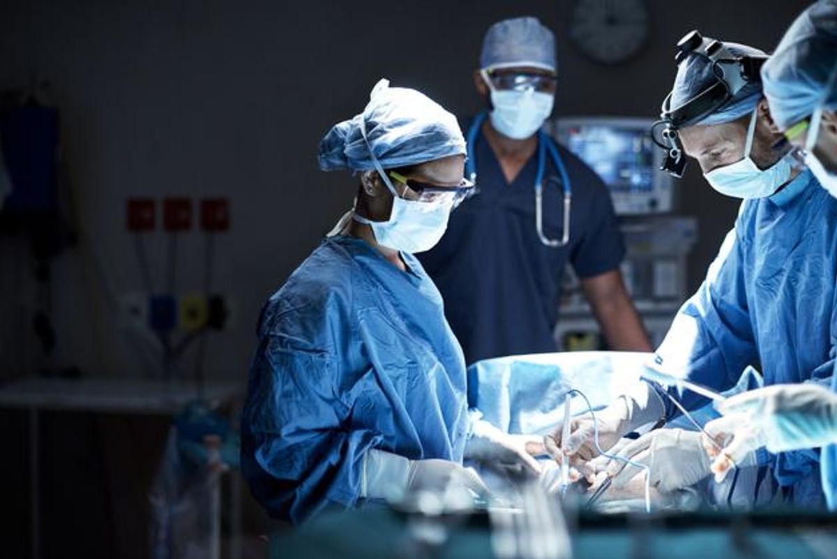 Shot of a team of surgeons performing a surgery in an operating room