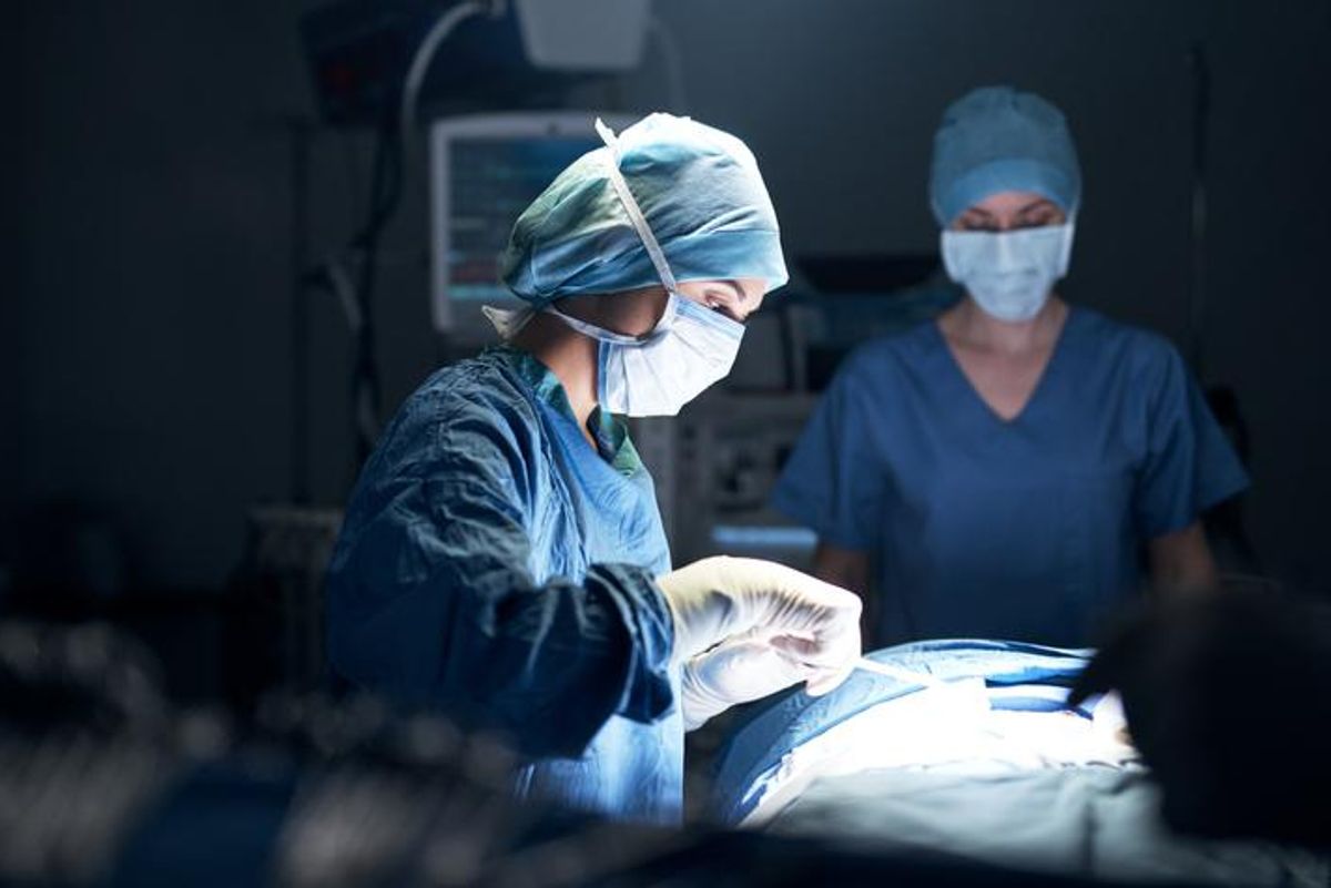 Shot of surgeons performing surgery in an operating theatre