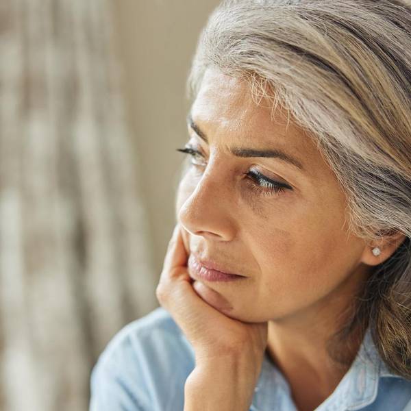 Shot Of Thoughtful Mature Woman Looking Out Of Window