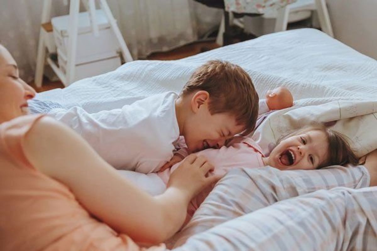 siblings playing with their mother