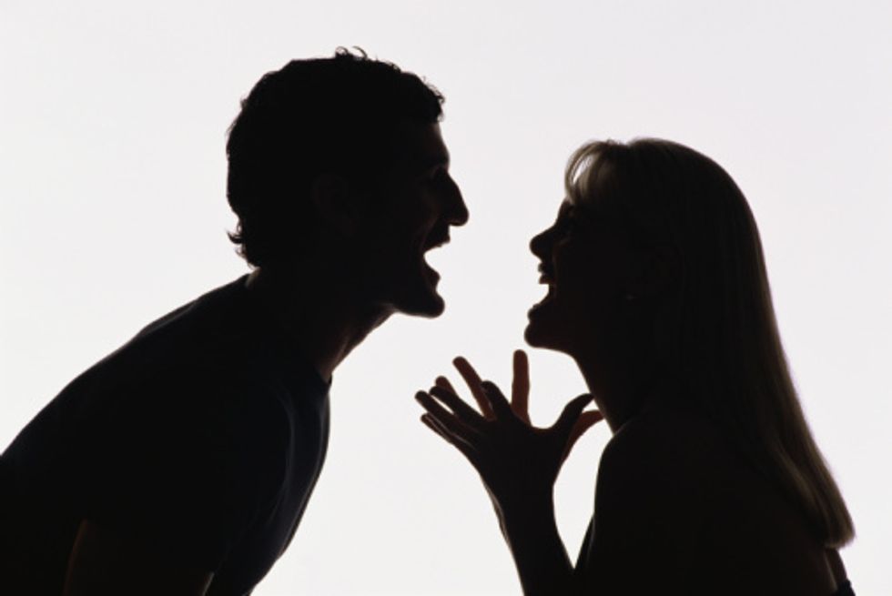 silhouette of a couple fighting