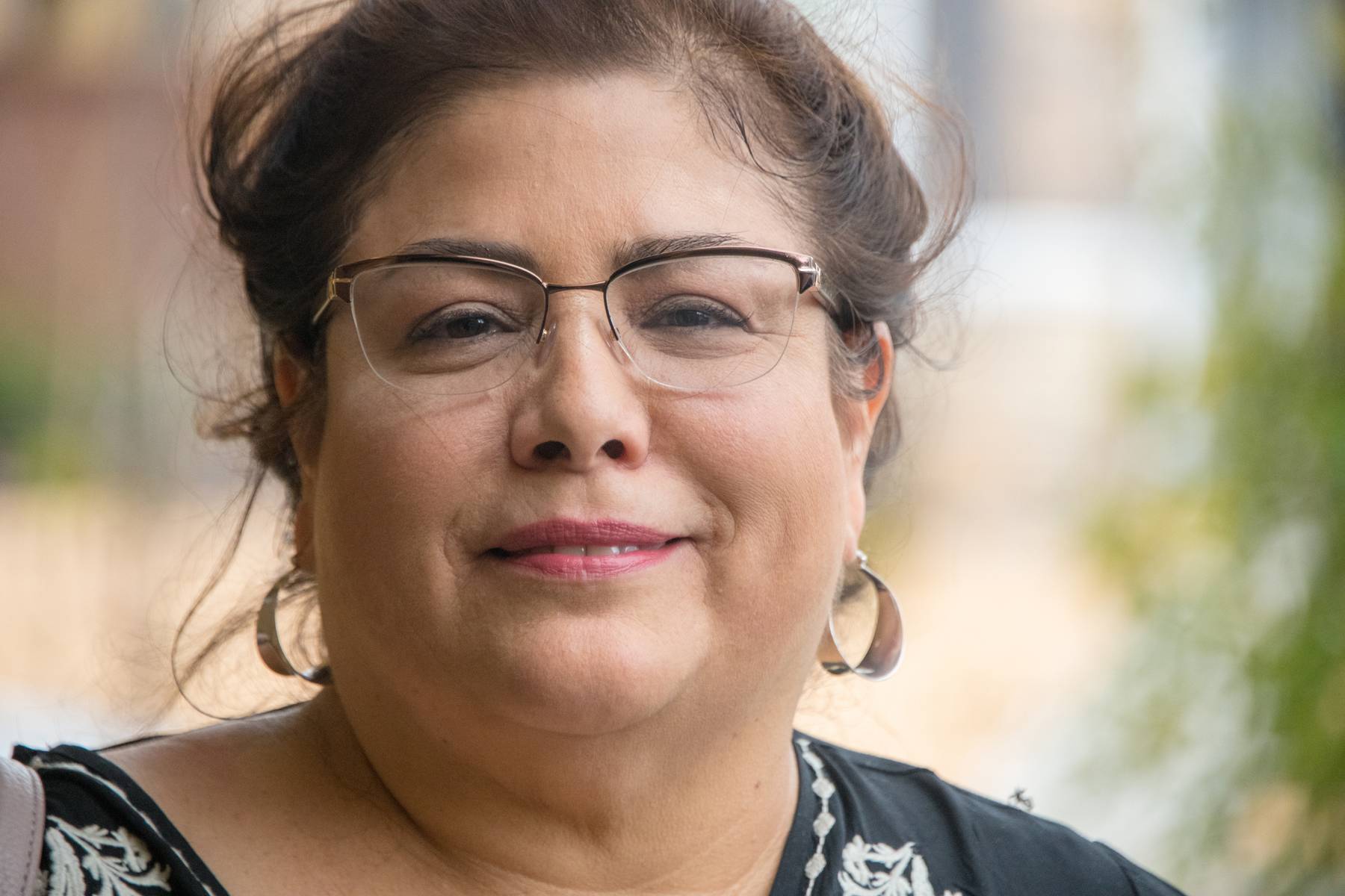 Smiling overweight hispanic woman dealing with thyroid issues