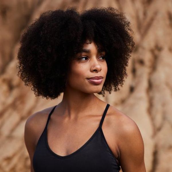 Smiling young African American woman in sportswear