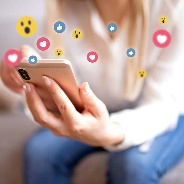 Smiling young woman with mobile phone Surfing the internet
