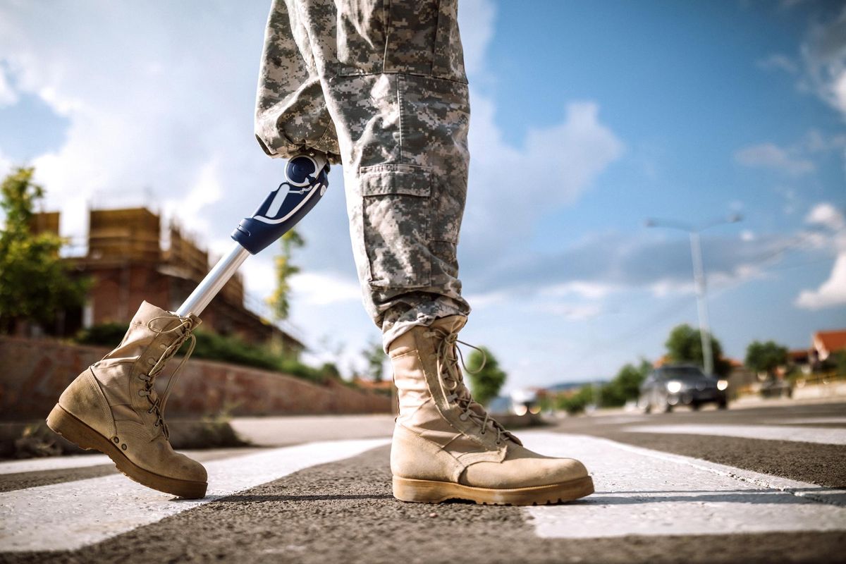Soldier with prosthetic leg crossing road